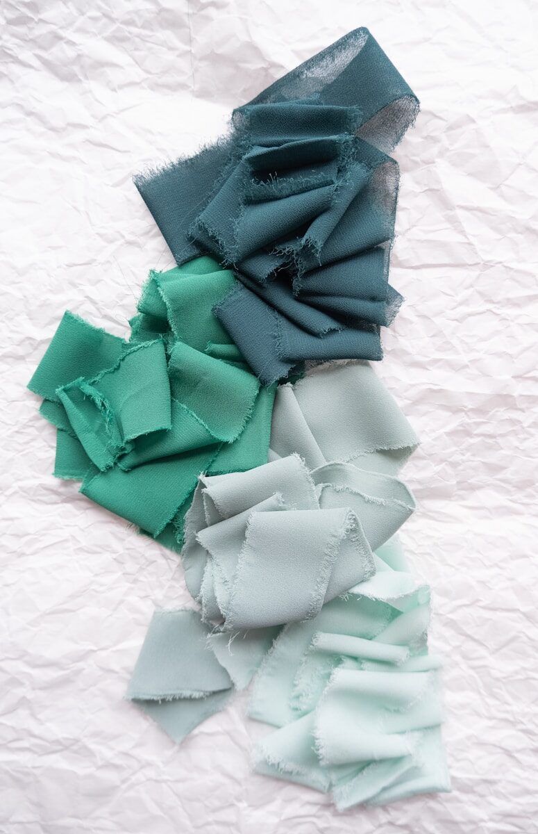 Photo by Fiona Murray-deGraaff a pile of different colored pieces of cloth