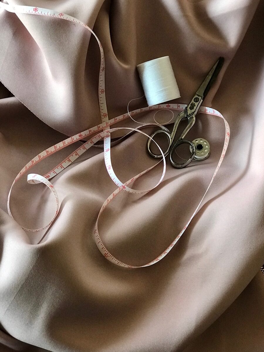 Photo by pina messina white tape measure and gray scissors