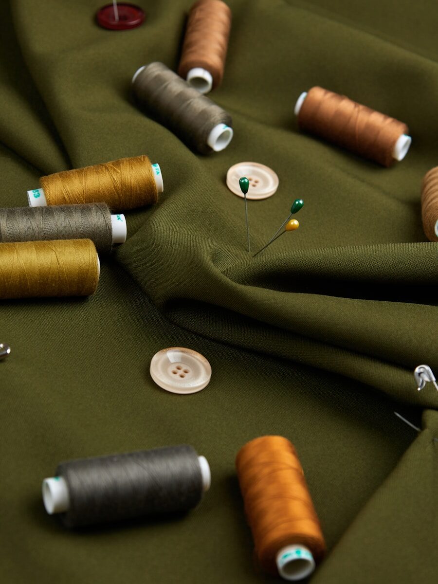 Photo by Victor Volkov a table topped with lots of different colored spools of thread
